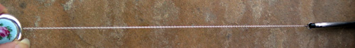 STERLING SILVER CROSS PENCIL ON RETRACTING CABLE BROOCH